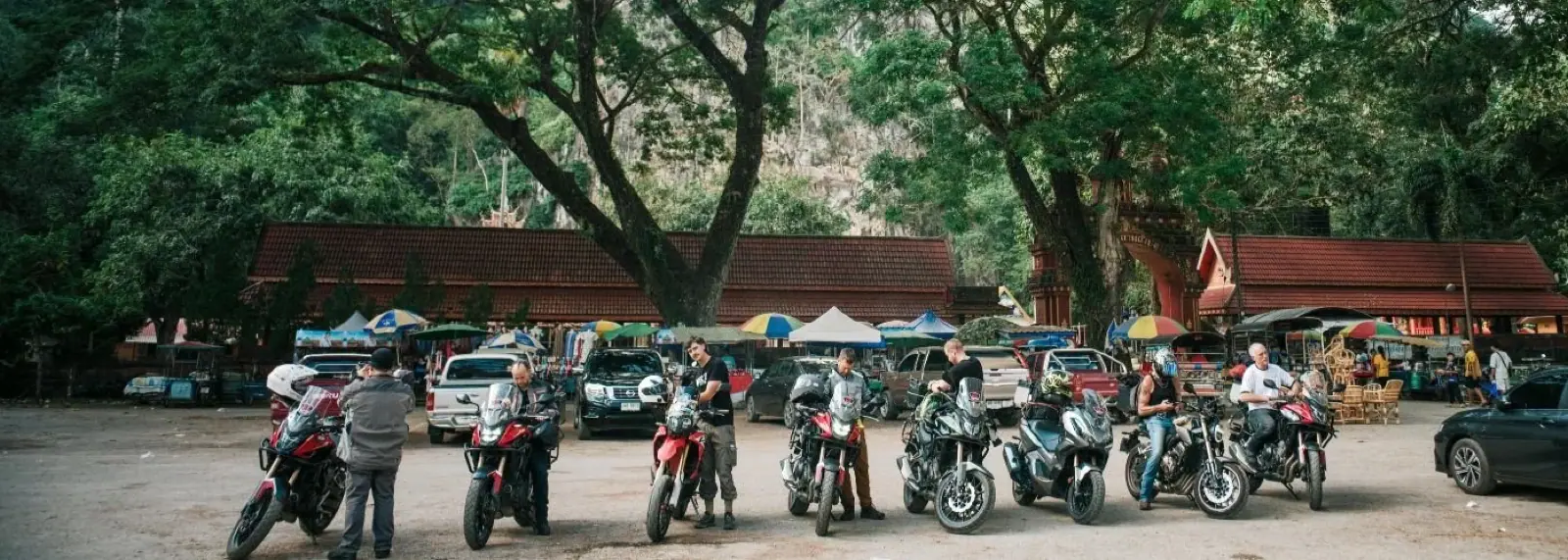 Riders stopping at a market in Northern Thailand