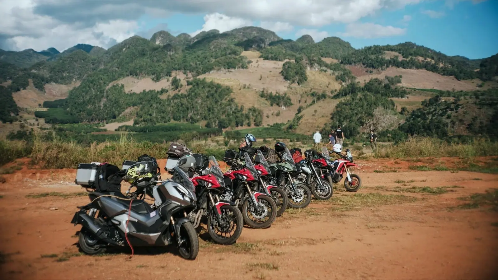 Motorcycles parked beneath the Northern Thailand mountains